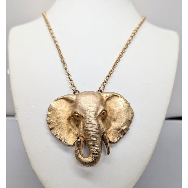 1970s goldtone matte elephant pendant with shiny edges to the earrings on a chain necklace with spring ring clasp. Marked...