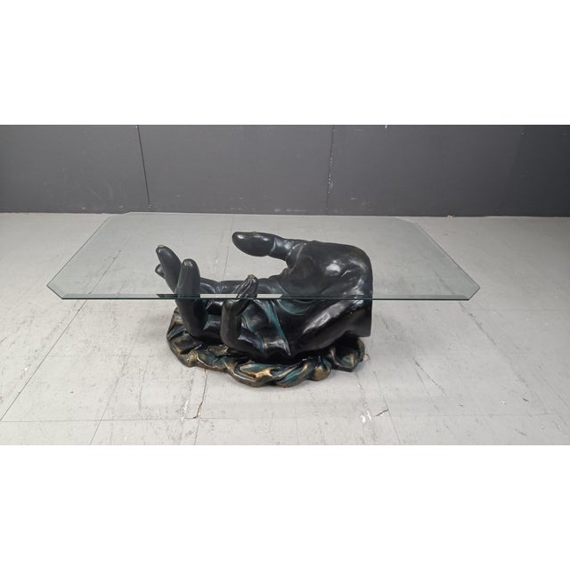 Sculptural bronzed plaster coffee table with a hand shaped base and a clear beveled glass top. Very good condition 1980s -...