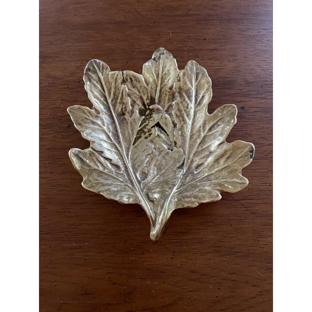 Brass chrysanthemum Catchall / ashtray in good condition. There is some darkening to one spot on the face of the piece....