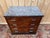 Art Deco four-drawer commode, circa 1930, in solid walnut and burr walnut veneer with a book-matched, symmetrical...