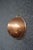 English copper mixing bowl with a rounded form, rolled rim, and brass hanging loop. Stamped "Made in England," this piece...