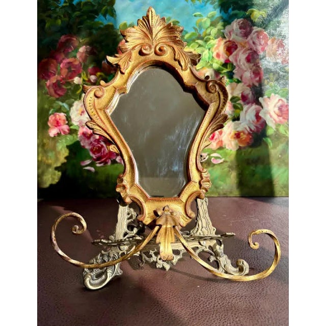 Beautiful circa 1950s Italian Florentine gold-gilded vintage mirror, wood wall decor with metal towel holder at the...