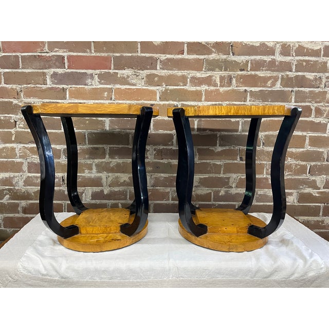 Pair of vintage Art Deco inspired dual tiered side tables with circular top and base showing a blonde ash or olive burl...