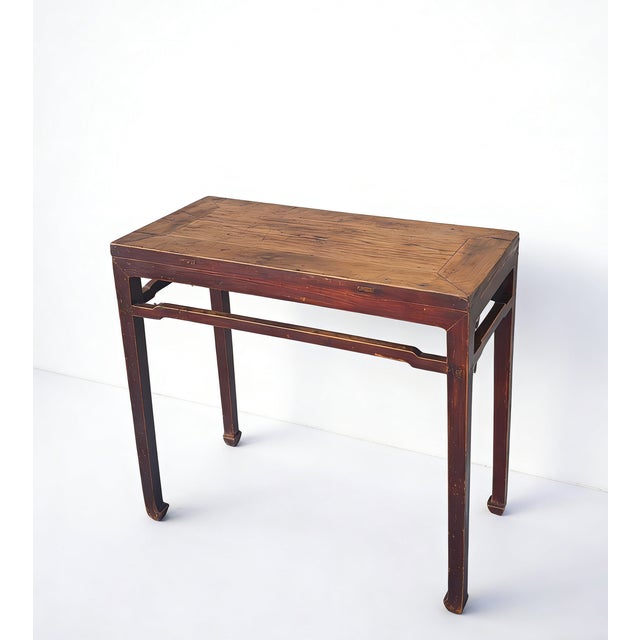 This rectangular console table features a traditional square-corner construction with a natural elm wood top set into a...