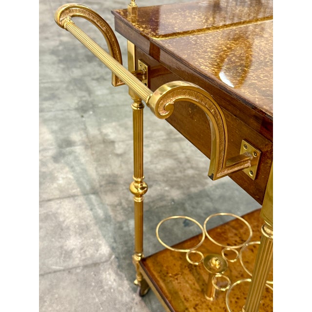 Elegant Italian bar cart crafted from richly figured burl wood with polished brass details. The design features two...