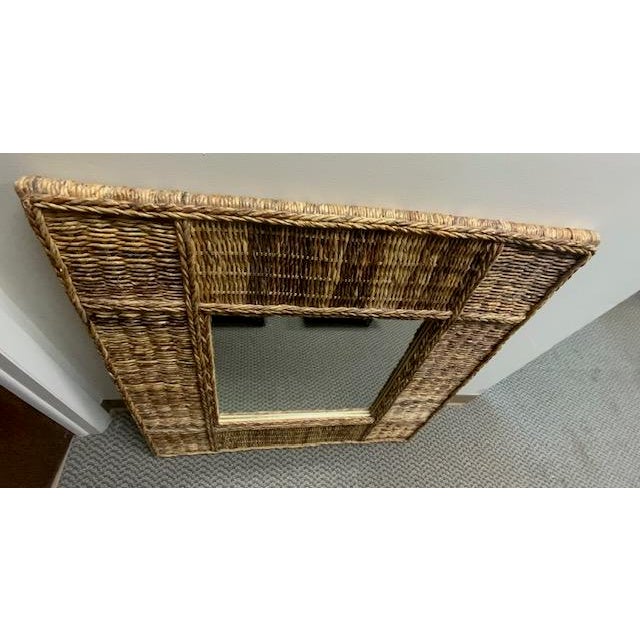 This woven wicker mirror is a bohemian style design that is beautiful for any home. This style features hand woven abaca....