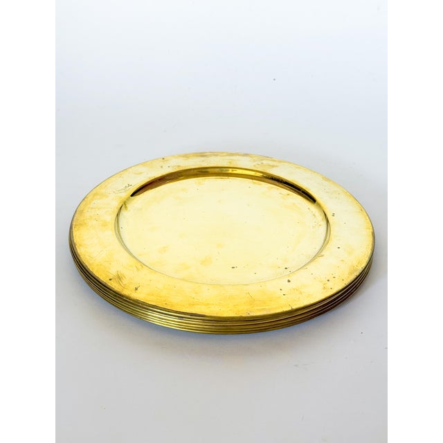 Lovely set of six vintage Mid-Century brass Scanmalay chargers, made in Denmark. These chargers are heavy and have a...