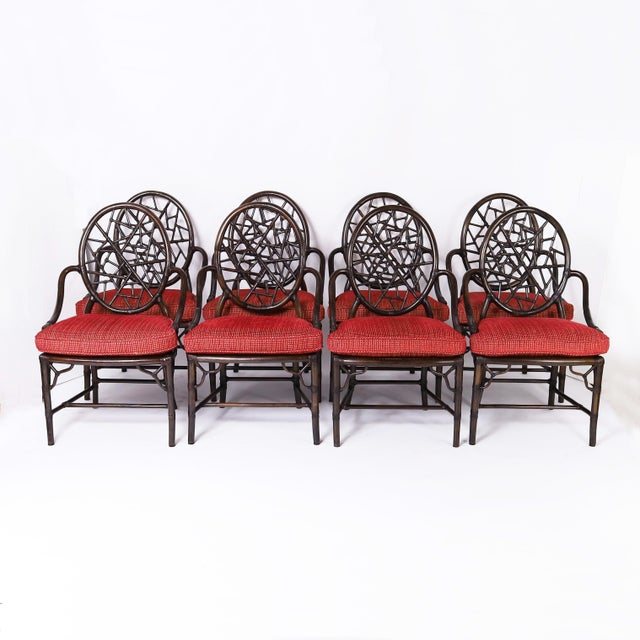 Impressive mid century set of eight armchairs crafted in mahogany with reed wrapped joints featuring stylized Chinese...