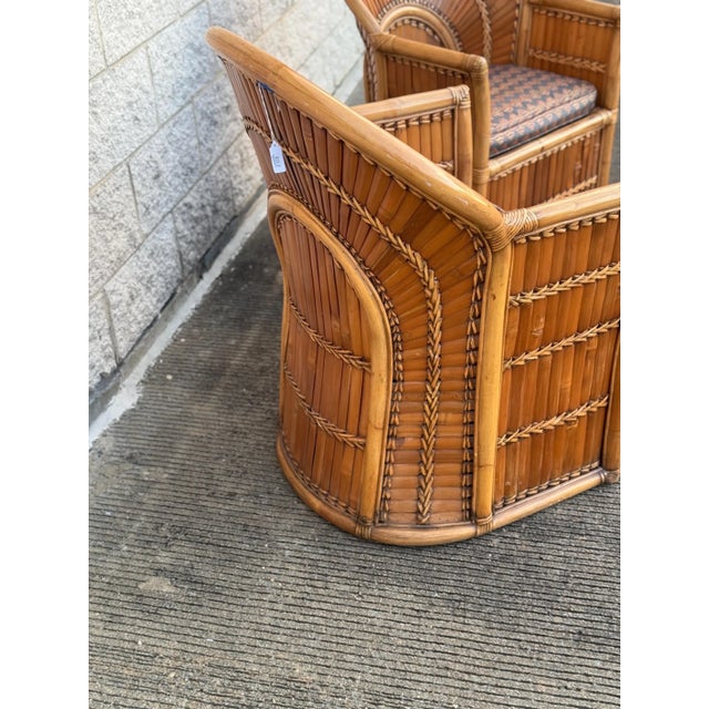 Patio lounge chairs made from woven split bamboo, the backs in a fan arrangement, with removable seat cushions.