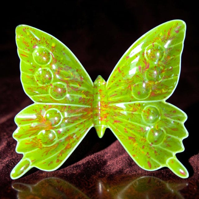 This vintage ceramic trinket holder dish features a green butterfly design, making it a charming decor piece for any room....