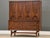A mid century modern walnut six drawer tall dresser with swooping walnut and brass arch details made by Broyhill Brasilia....