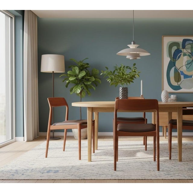 An elegant set of four chairs in golden brown teak, designed by Henning Kjærnulf for KS Møbler in Denmark. with its soft...