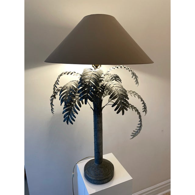 A handcrafted 1985 Sarreid Ltd. metal palm tree lamp featuring layered fronds and an embossed stepped base. Made from...