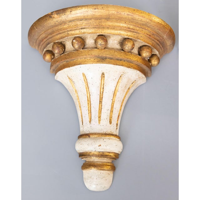 A gorgeous pair of vintage Italian Neoclassical style gilt wood wall brackets or corbels with a lovely patina, circa 1950....