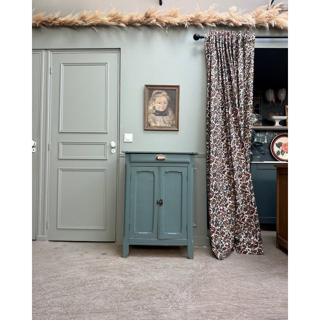 This small, antique parisian sideboard from the mid-20th century offers practical storage in a compact size. Its simple...