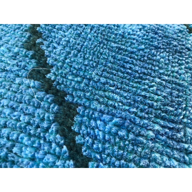 This is a vintage Turkish Oushak rug from the 1960s. The piece was hand-knotted.