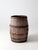 Antique wooden barrel with a tall, classic form, featuring weathered wood staves and aged iron banding. The surface...