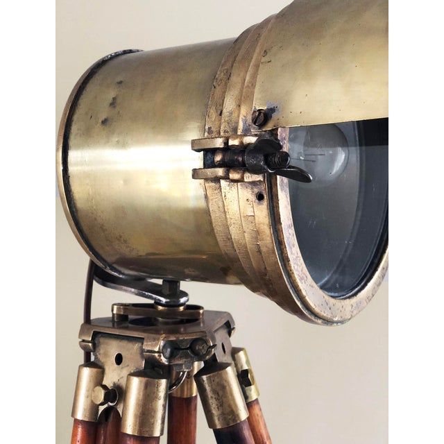 This antique industrial floor lamp features an original early 20th-century wooden surveyor tripod combined with a vintage...