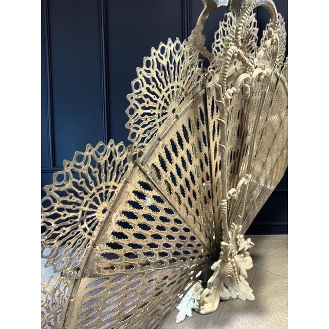 Beautiful antique peacock fireplace screen Consists of 9 panels that overlap. Maximum open dimensions: height approx. 59...