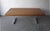 This is a striking vintage dining table featuring a substantial solid oak top paired with a sleek aluminum trestle base....