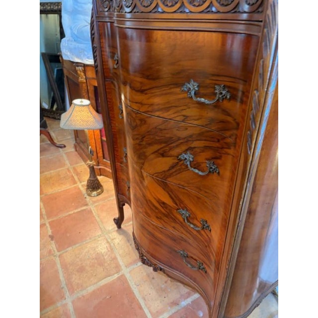 This tall 5 drawer antique walnut American chest of drawers in French style is a beautiful and functional piece of...
