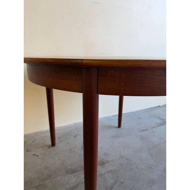 Beautiful vintage Danish round dining table crafted in warm teak and made in Denmark. This classic Mid Century Modern...