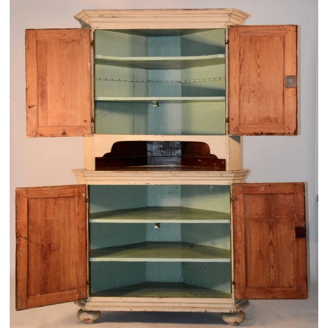 This piece is in a beautiful cream color with yellow doors. It boasts a pretty turquoise color on the inside with multiple...