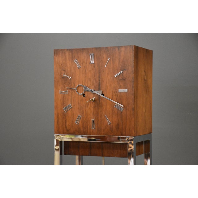 A mid century modern rosewood and chrome wind up Connoisseur clock with a light up bottom made by Ridgeway. Professionally...