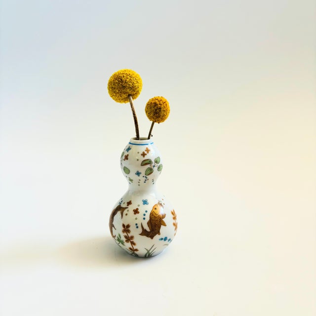 A small vintage gourd shaped ceramic vase. Decorated in a lovely fish design. Made in Japan in 1980. 2 are available for...