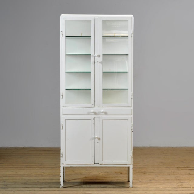 Medicine cabinet from the 1950s, manufactured in former Yugoslavia. This cabinet is made of iron and glass, creating a...