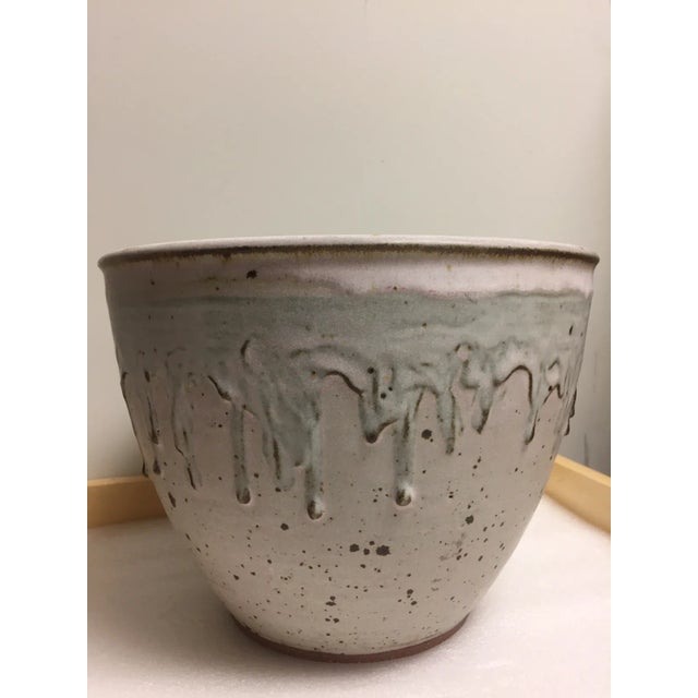 Mid century modern off white and blue-grey drip glaze studio pottery decorative bowl. Engraved artist I rials on the bottom.