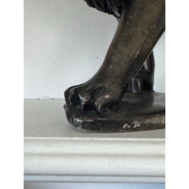 A substantial hand-carved stone lion sculpture, rendered with a strong, grounded presence and a sense of permanence that...