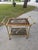 This vintage Hollywood Regency bar cart embodies mid-century glamour with its rich burl veneer, sculptural brass frame,...