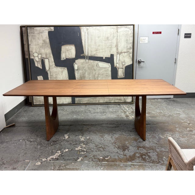 Design Plus Gallery presents the Arco Extendable Dining Table from Rove Concepts, manufactured by Kaye. Walnut veneer...