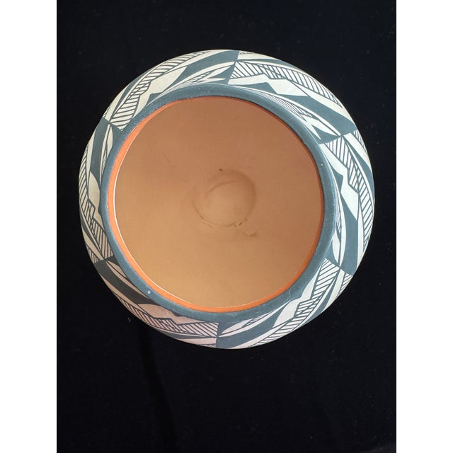 Hand-coiled Acoma Pueblo pottery jar, signed J. Garcia on the base. Measures approximately 6 inches tall by 6 inches wide....