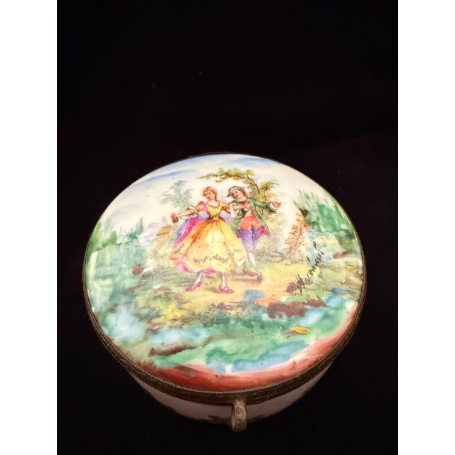 This rare Victorian era hand painted porcelain trinket box with a cover and brass hardware is signed, "Made in Germany"....