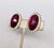 Circa 1960s oval goldtone with oval disco-like cut faux-garnet surrounded by small round clear rhinestones clip earrings....