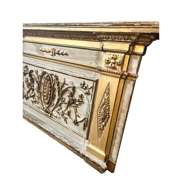 Circa 1800, the panel with an overhanging cornice ornamented with egg-and-dart carving, the primary tablet painted white...