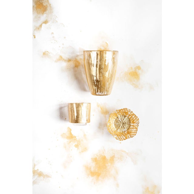 The Rufolo Gold Brushstroke Votive The Rufolo Glass Gold Brushstroke Votive brings luster to your table. The glass piece...