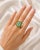 Elegant 18K yellow gold mosaic statement ring featuring a natural emerald-cut aquamarine centerpiece weighing 4.24 carats....