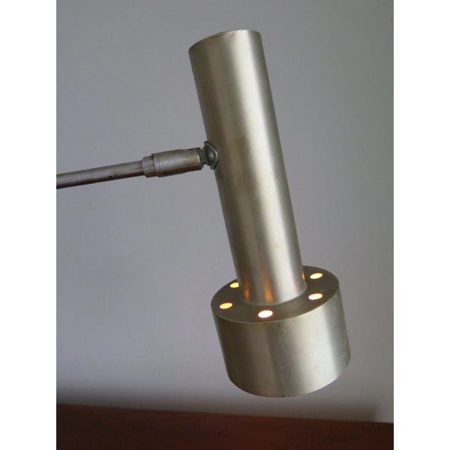 A Minimalist table lamp by RAAK, Holland, circa 1960. Steel and brushed aluminum, pivoting shade.