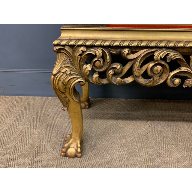 A bold and highly decorative red lacquered chinoiserie cabinet on stand. Dating to the early 20th century and of generous...