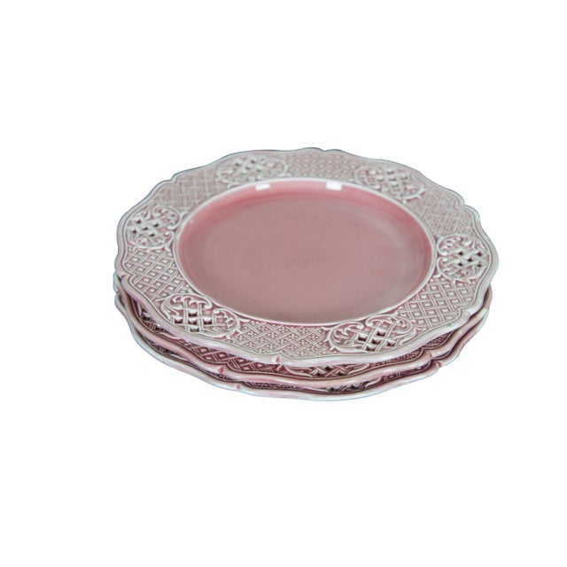 Three antique Austrian / Hungarian pink stoneware plates featuring a scalloped pierced basketweave lattice design. Marked...