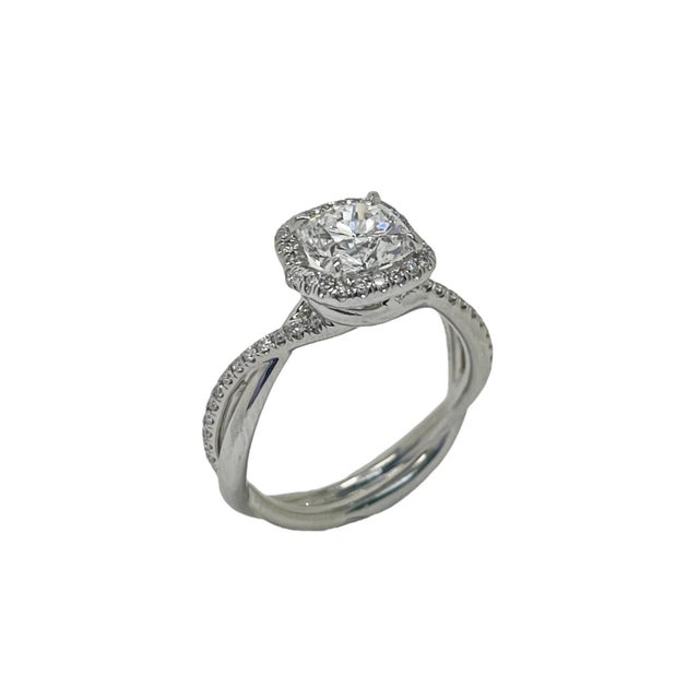 This elegant engagement ring contains a 1.22 carat cushion brilliant cut diamond, E color and SI1 clarity, this diamond is...