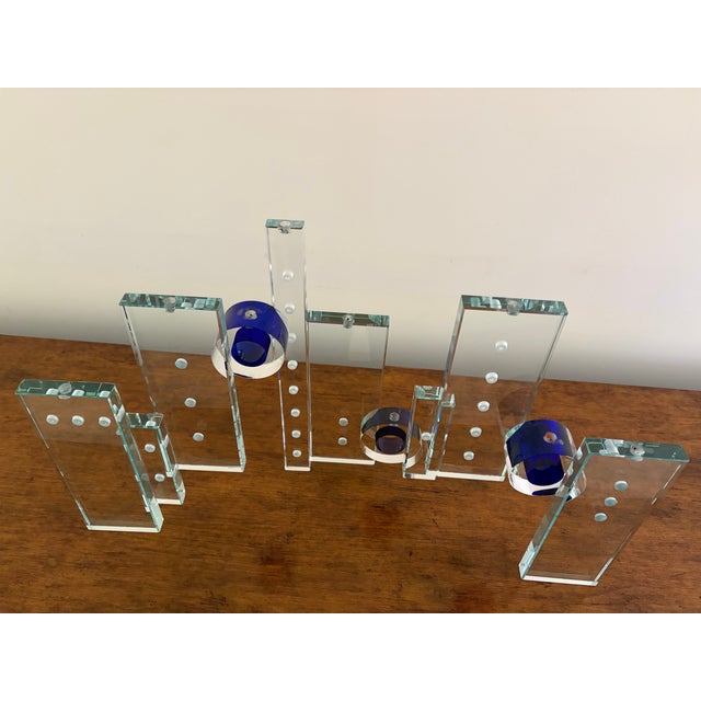Unique 14”H x 23”W x 6”D glass menorah sculpture by creative Fay Miller. Clear glass with intense bright blue accents.