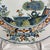 Pair of Majolica Plates with Carnation Decoration, Ferniani Manufacture, Faenza, painted in polychrome in shades of blue,...