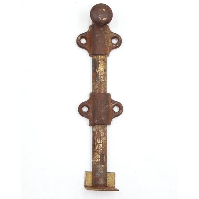 Vintage surface mount slide door bolt made of steel with an antique brass finish. The original mounting screws are not...