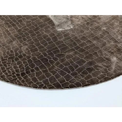 The Tutankhamon rug showcases an alligator skin-inspired pattern, lending a subtle, nature‑inspired luxury to interiors....