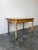 A quintessential piece of 19th-century English countryside charm, this antique pine table features a pale warm surface and...