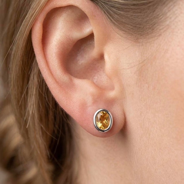 These elegant stud earrings feature radiant Citrine gemstones, admired for their warm golden-yellow glow and lively...